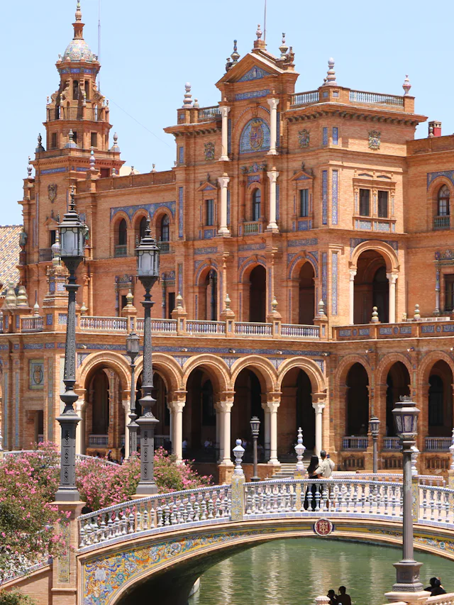 Seville's Plaza de España, tiled bridges over a canal below a curved colonnade