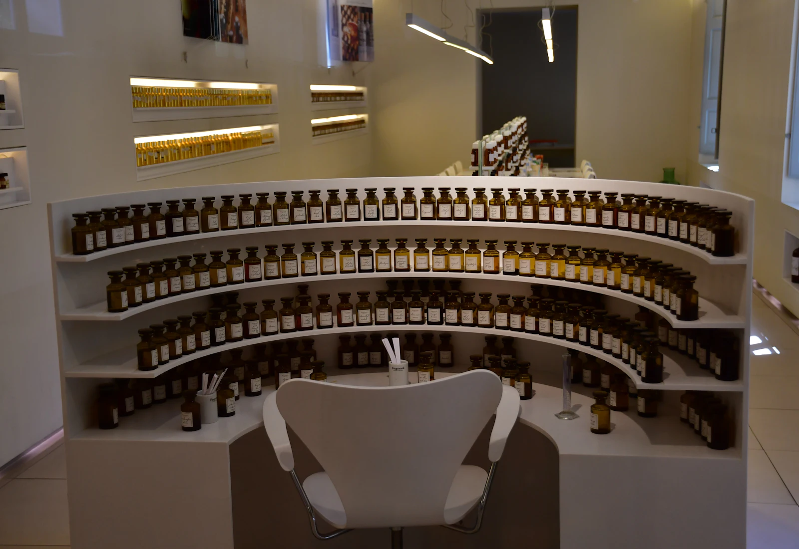 A perfumer's organ in Grasse: curved shelves of amber essence bottles